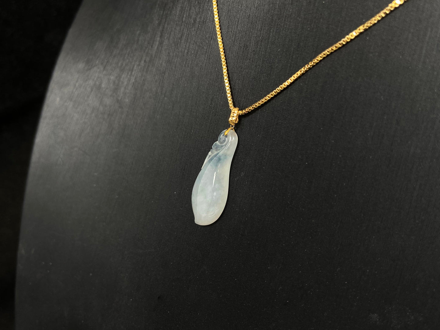 A milky white jadeite eggplant pendant.