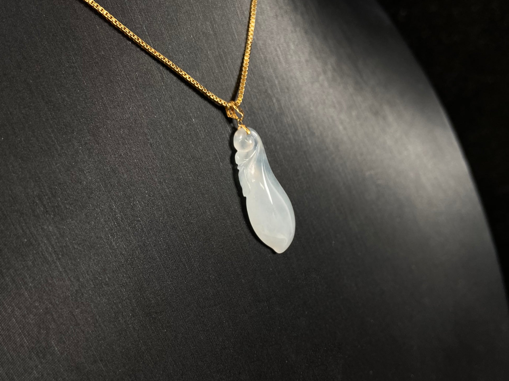 A milky white jadeite eggplant pendant.