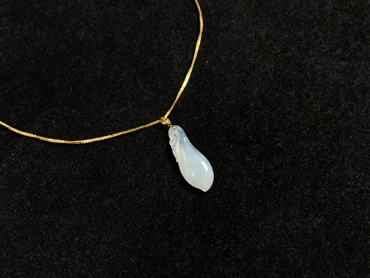 A milky white jadeite eggplant pendant.