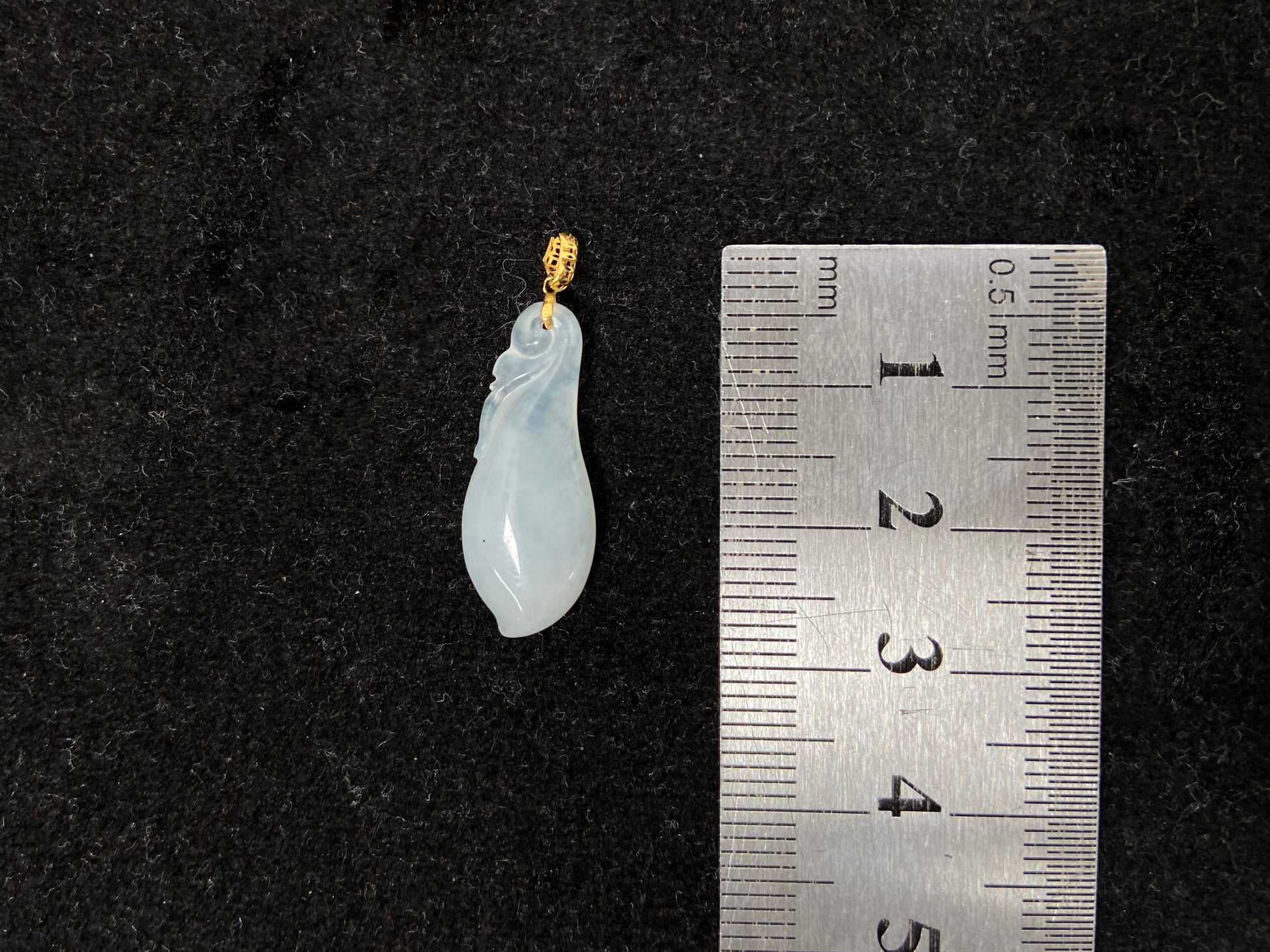 A milky white jadeite eggplant pendant.