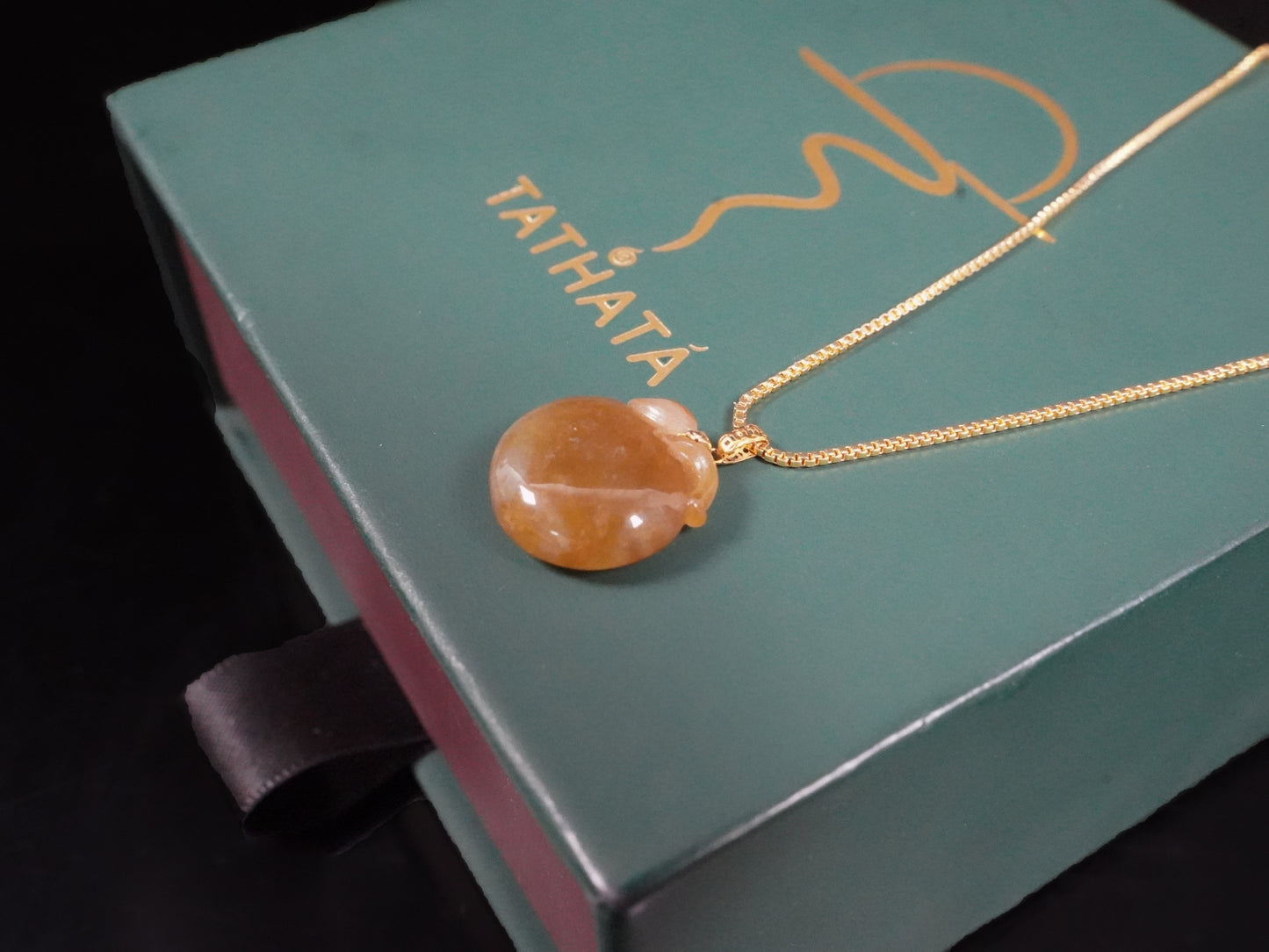 A warm amber-glazed apple Jadeite Pendant.