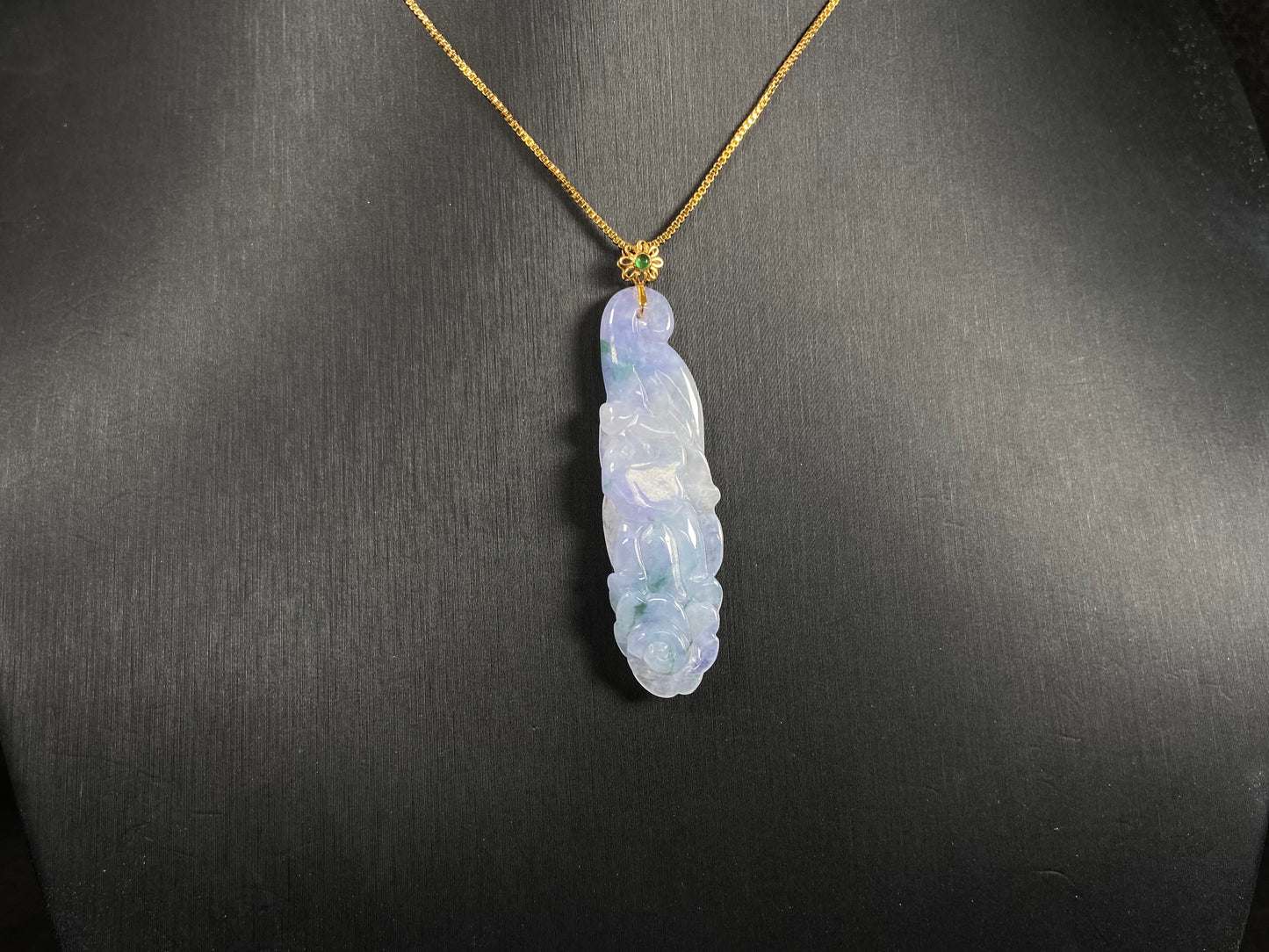 This pendant features a white and purple jadeite flower with hints of green.