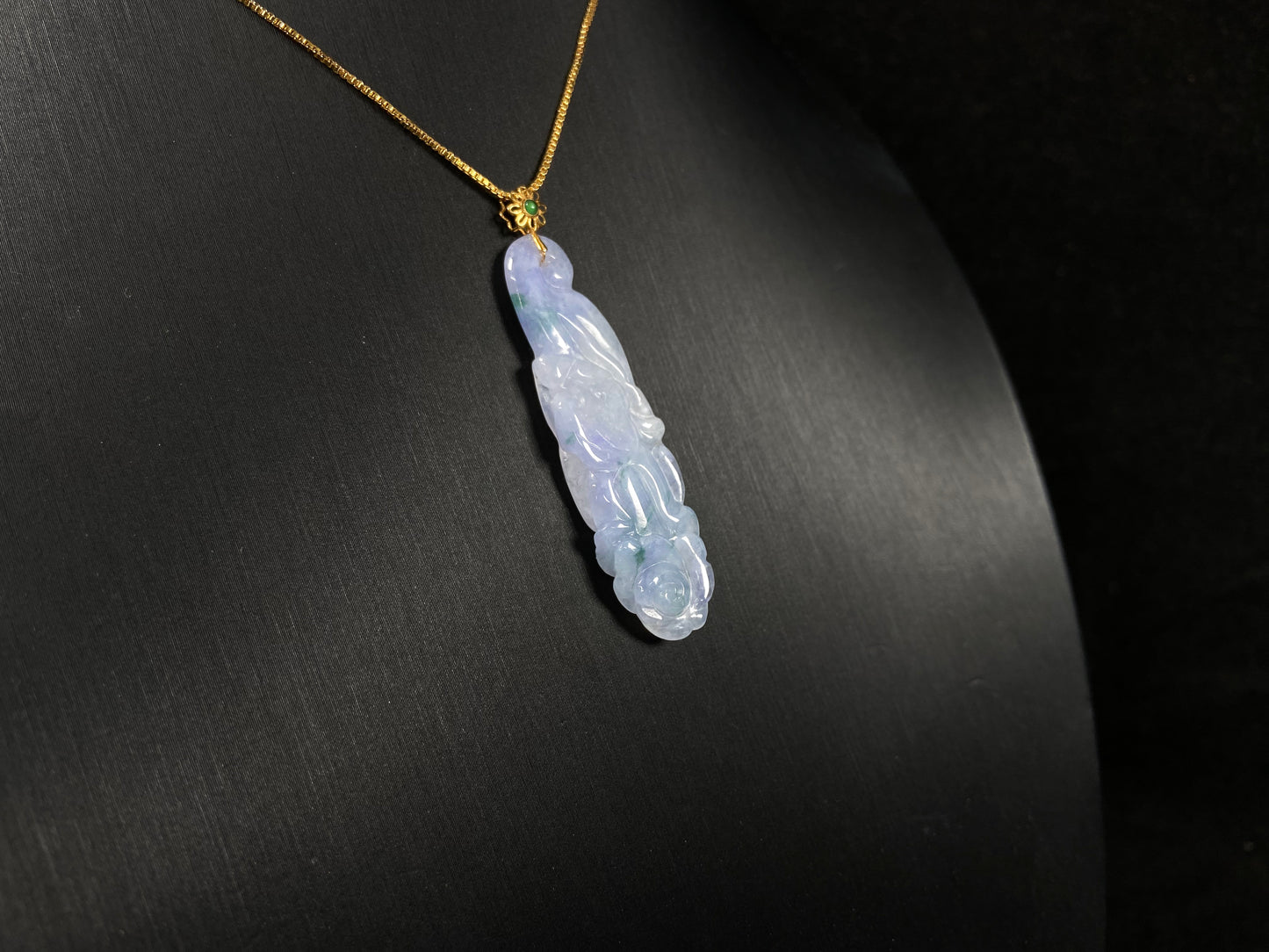 This pendant features a white and purple jadeite flower with hints of green.