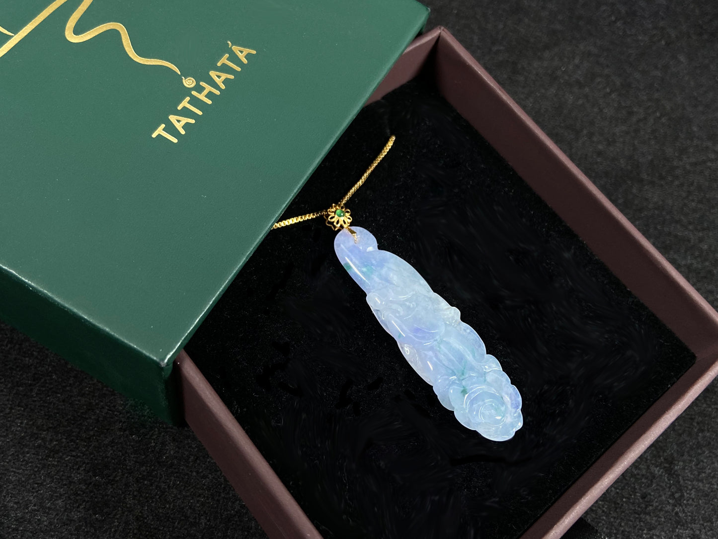 This pendant features a white and purple jadeite flower with hints of green.