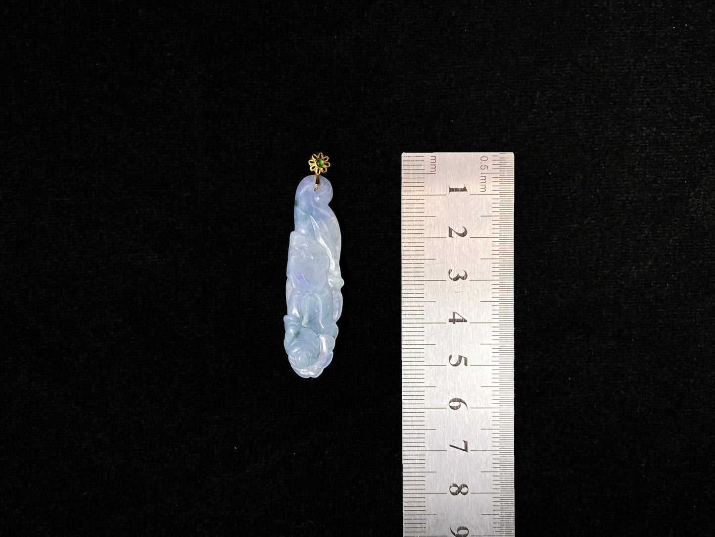 This pendant features a white and purple jadeite flower with hints of green.