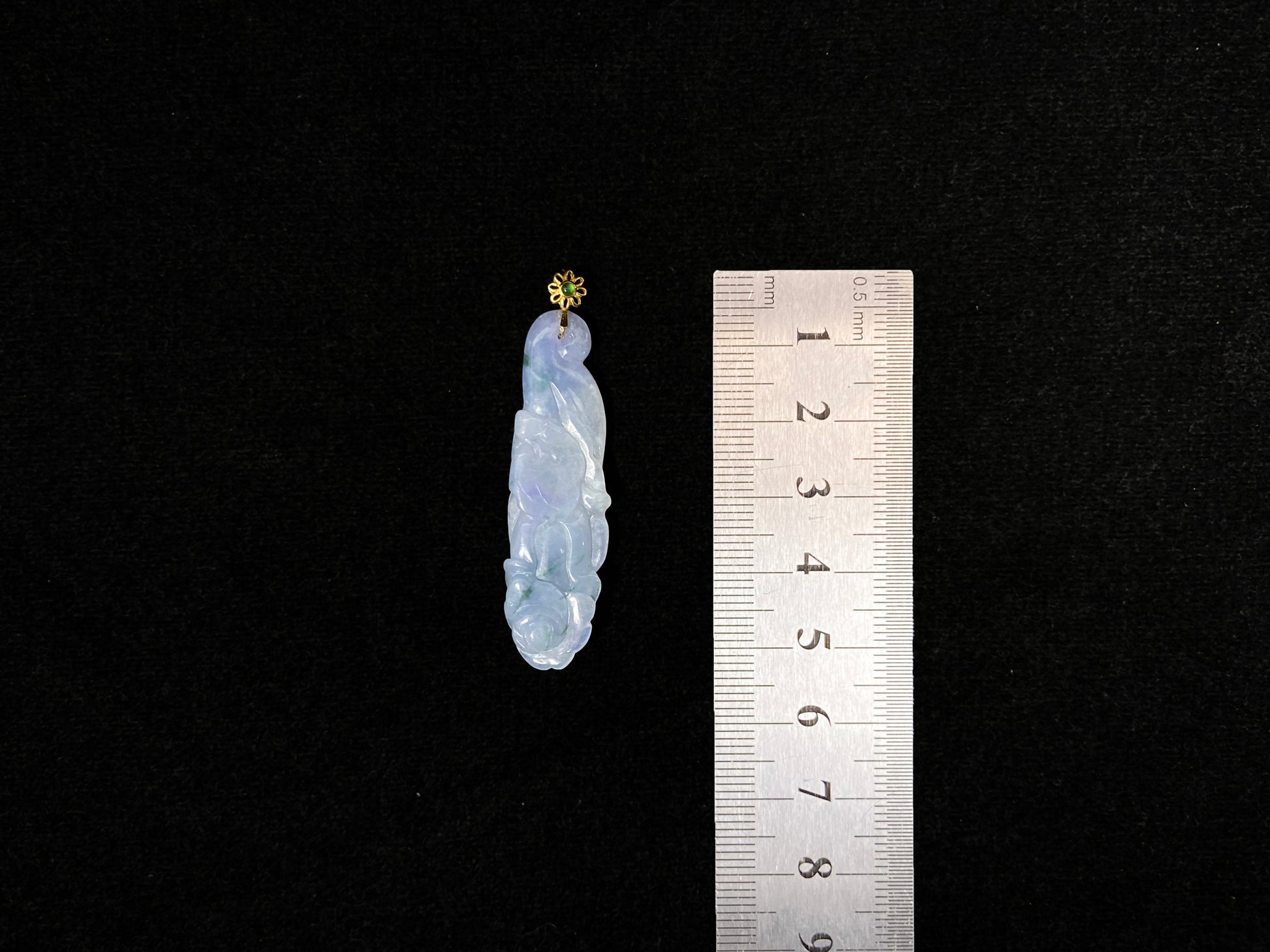 This pendant features a white and purple jadeite flower with hints of green.