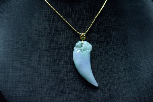 This jadeite pendant features a shark tooth shape in white, purple, and green.