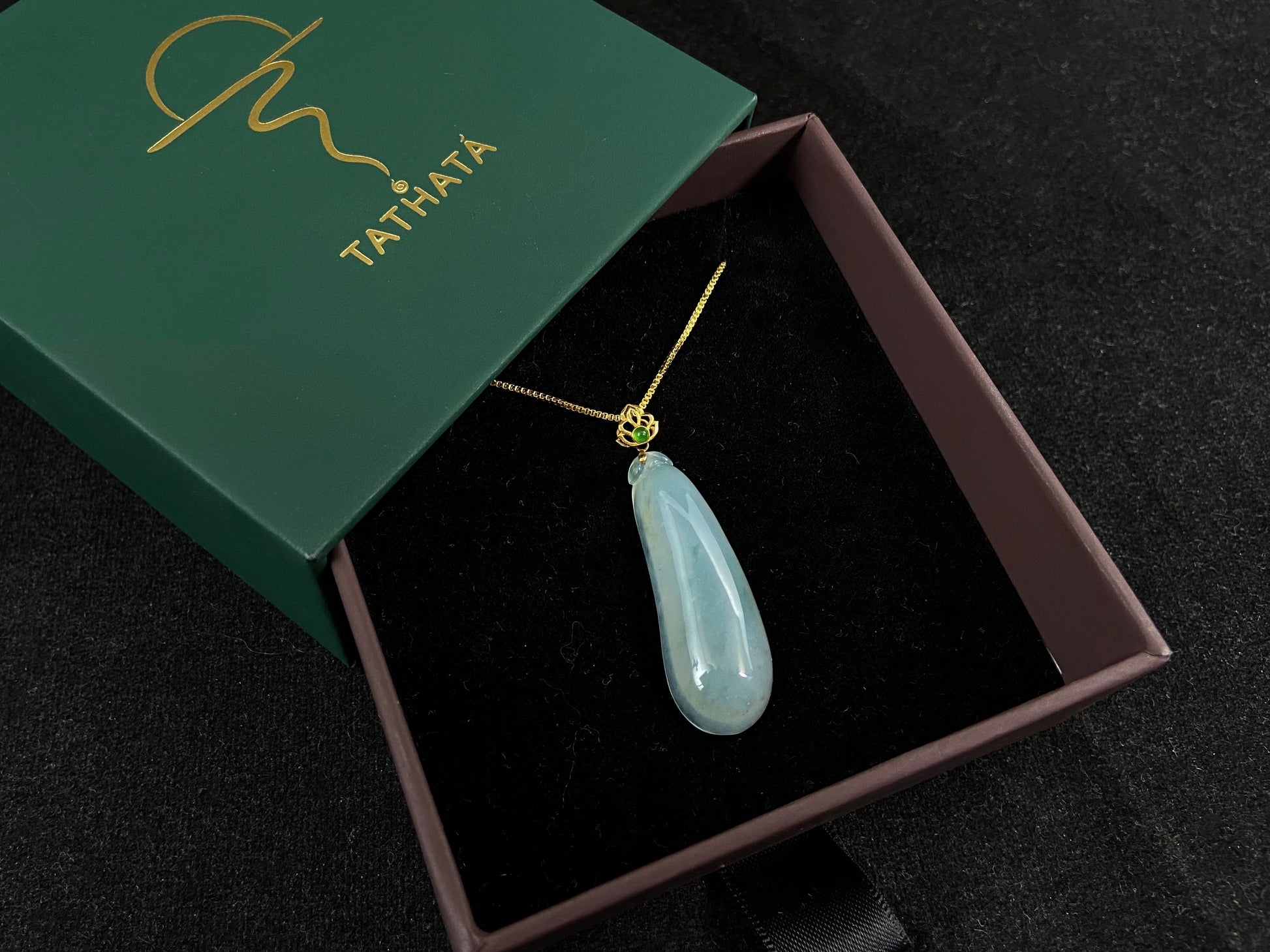 A pendant carved from translucent white jade into the form of a melon a Chinese symbol of good fortune.