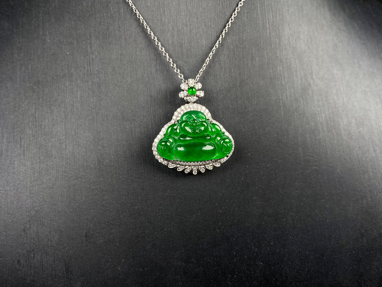 A imperial laughing buddha jadeite pendant.