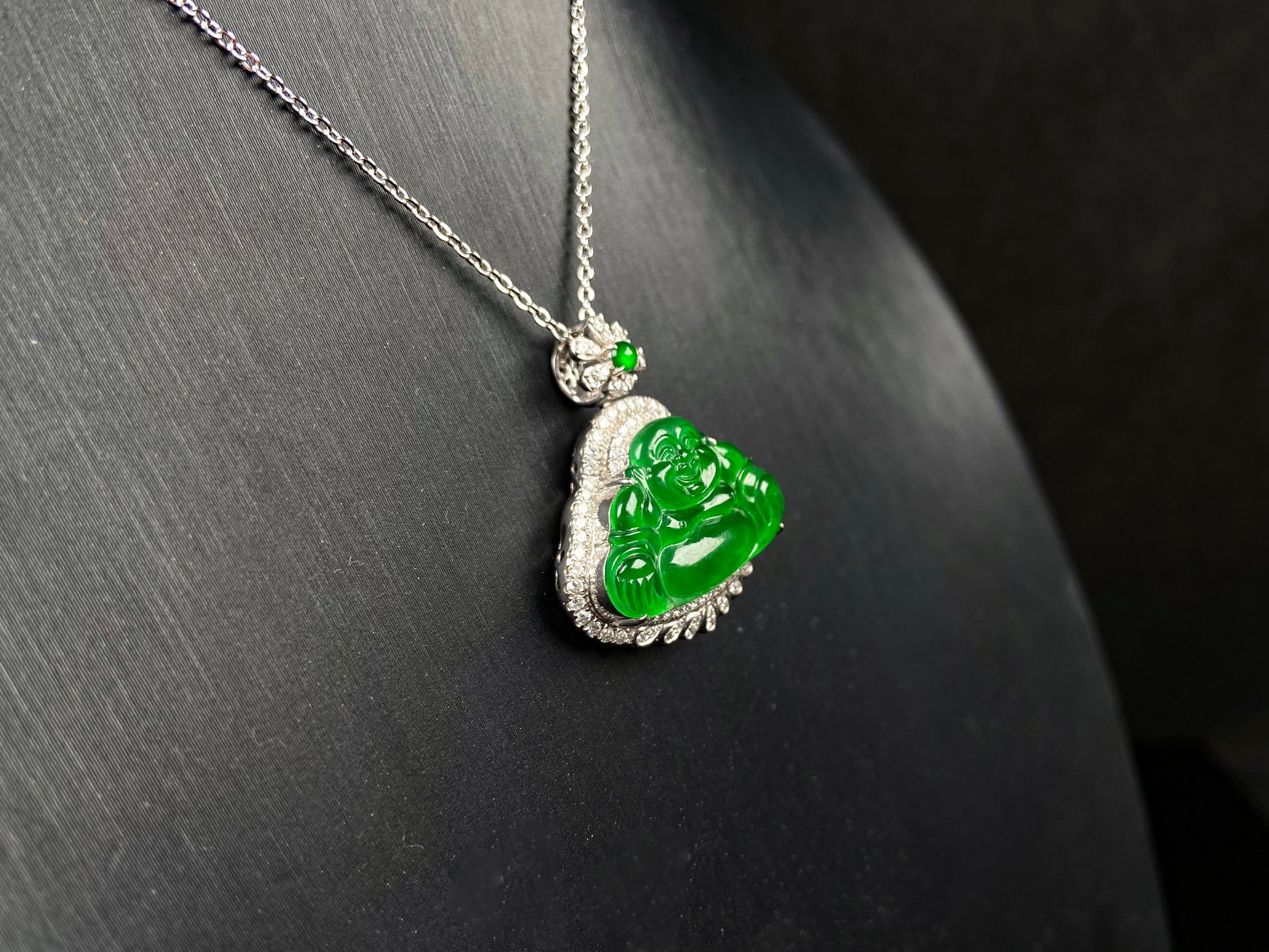 A imperial laughing buddha jadeite pendant.