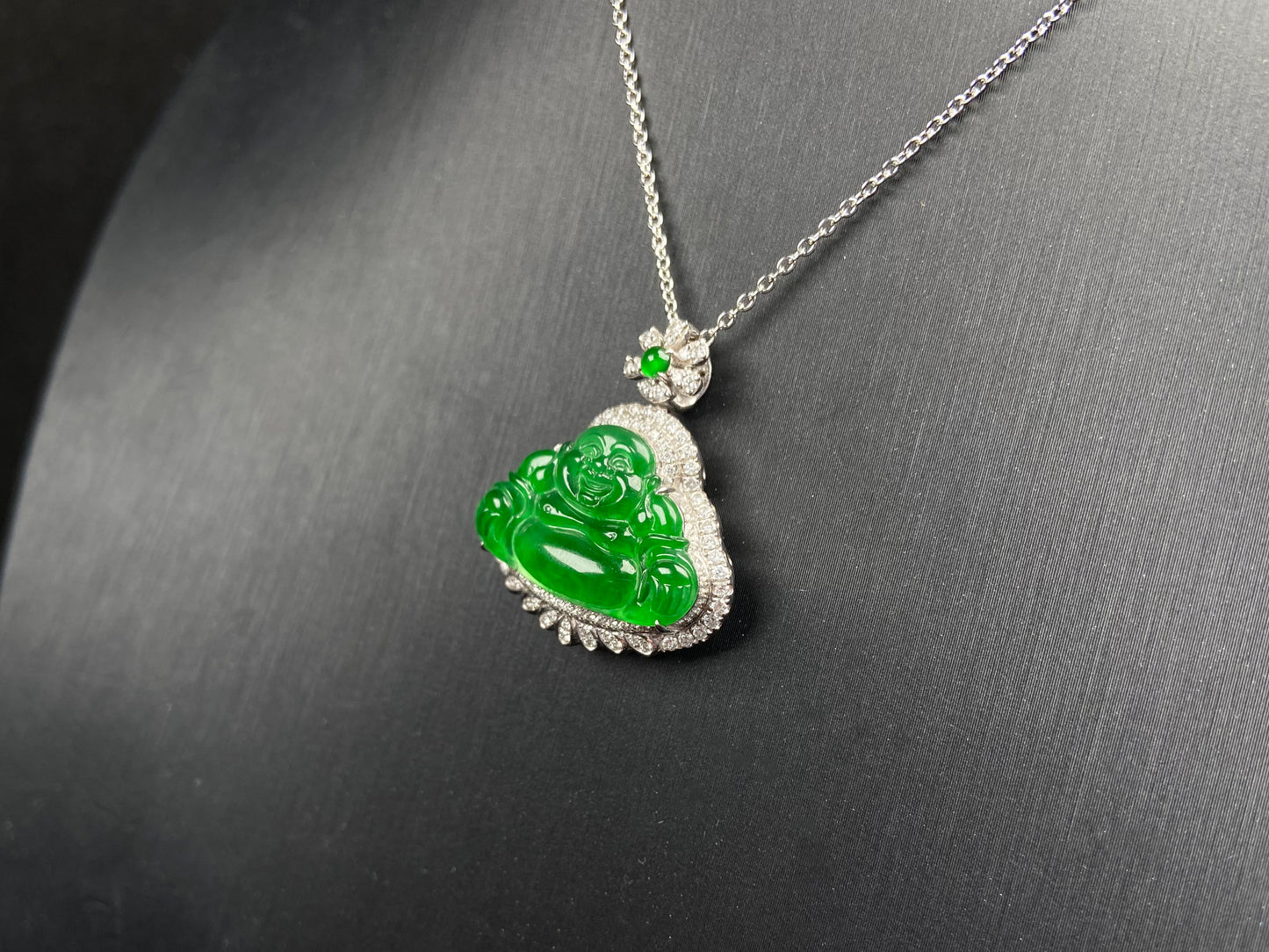 A imperial laughing buddha jadeite pendant.