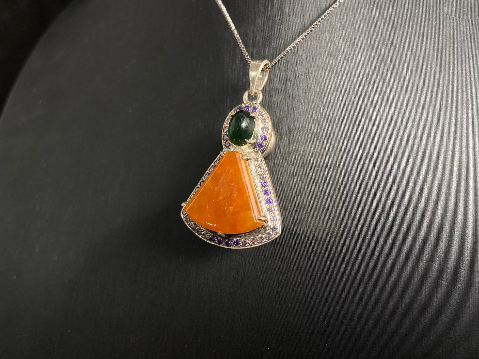 This unique pendant features an orange yellow "Wu Shi" plaque accented with a deep green jade bead, creating a striking color contrast.