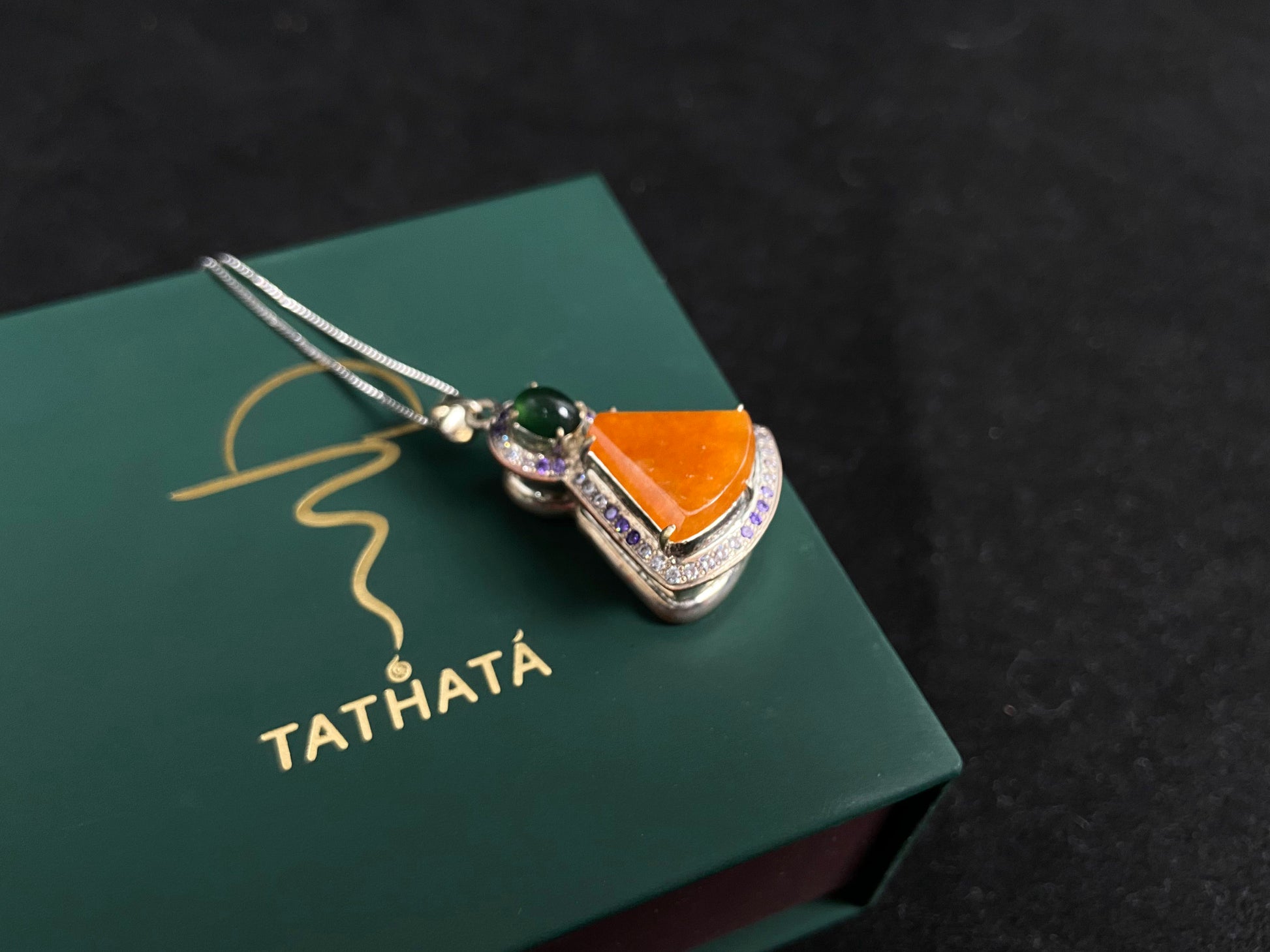 This unique pendant features an orange yellow "Wu Shi" plaque accented with a deep green jade bead, creating a striking color contrast.