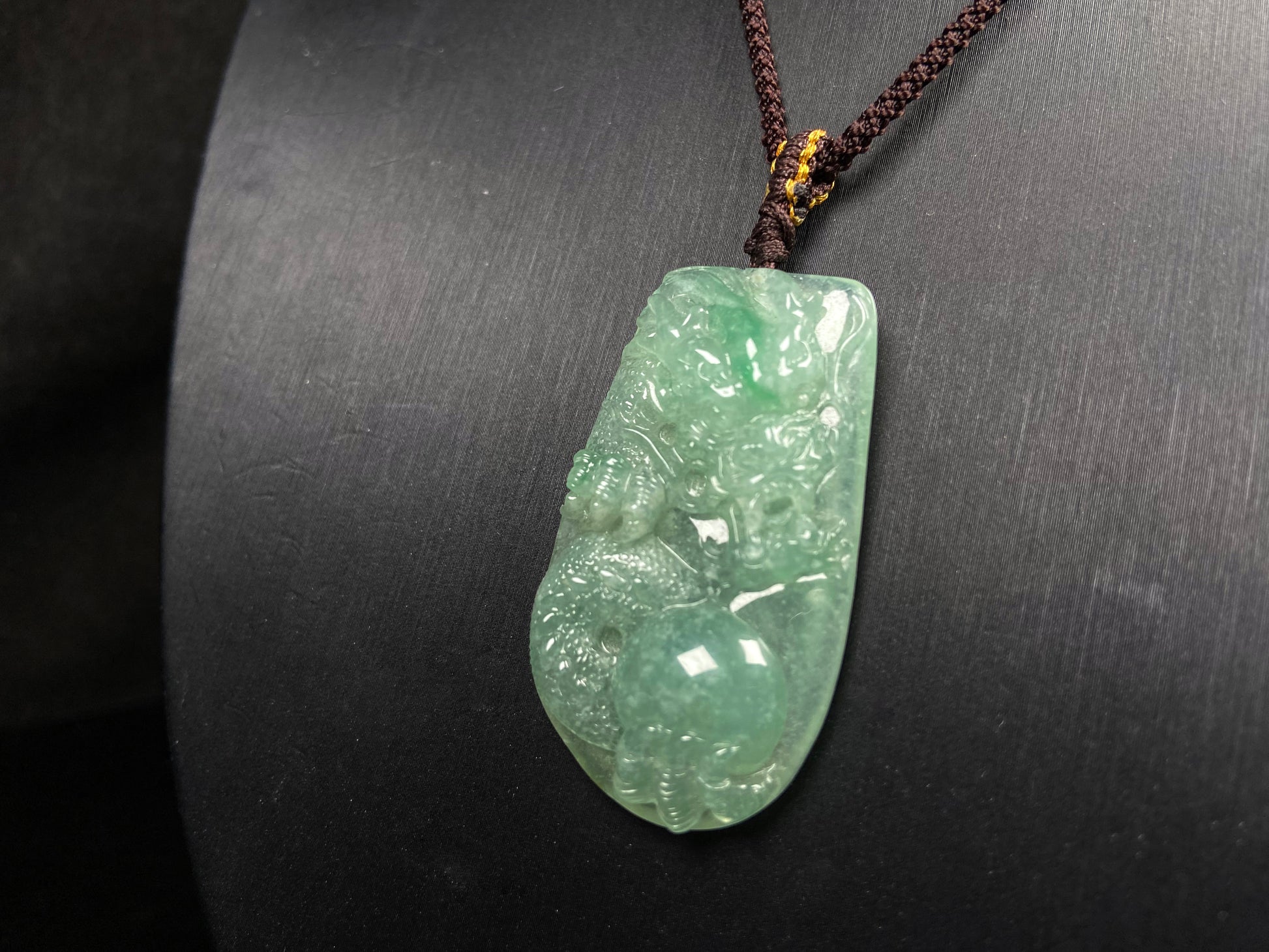 A green dragon playing pearl jadeite pendant.