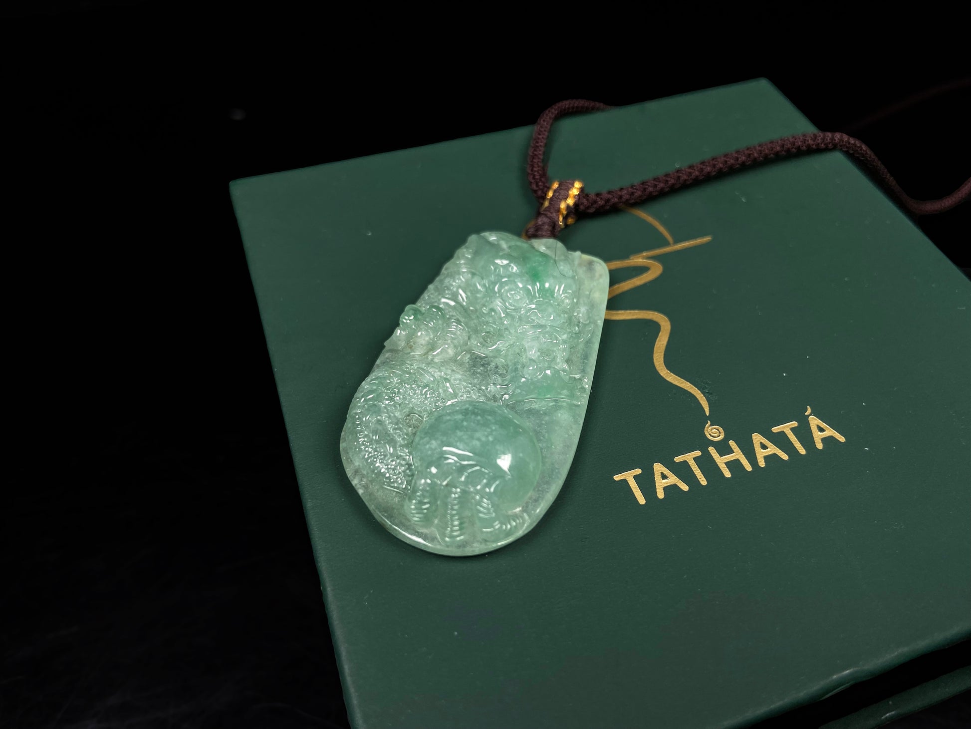 A green dragon playing pearl jadeite pendant.