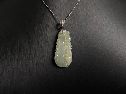 A translucent white jade bamboo pendant with a subtle golden glow.