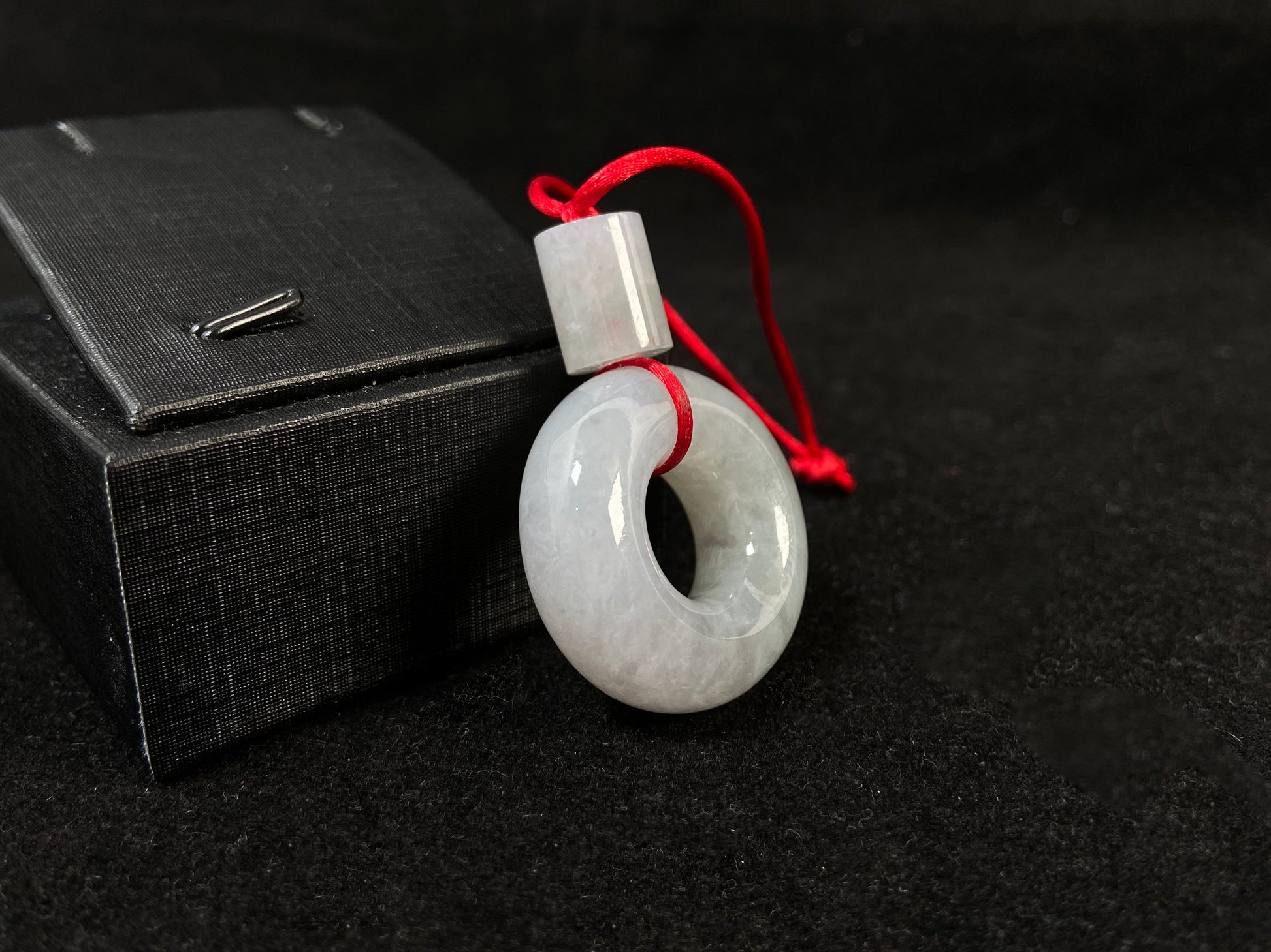 A milky white jadeite "Lu Lu Tong" pendant.