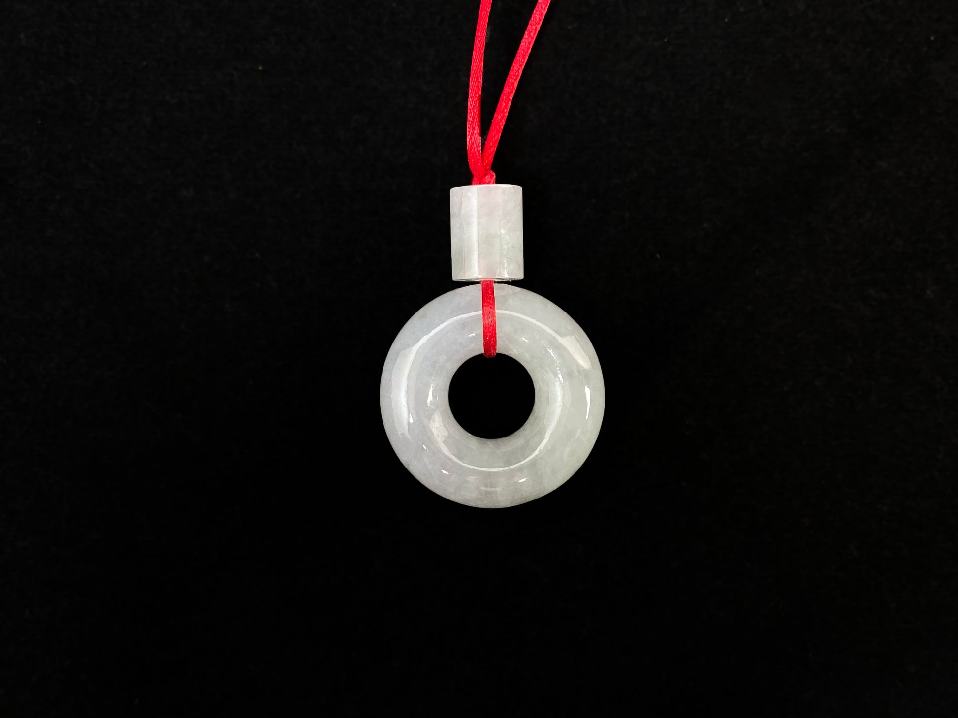 A milky white jadeite "Lu Lu Tong" pendant.