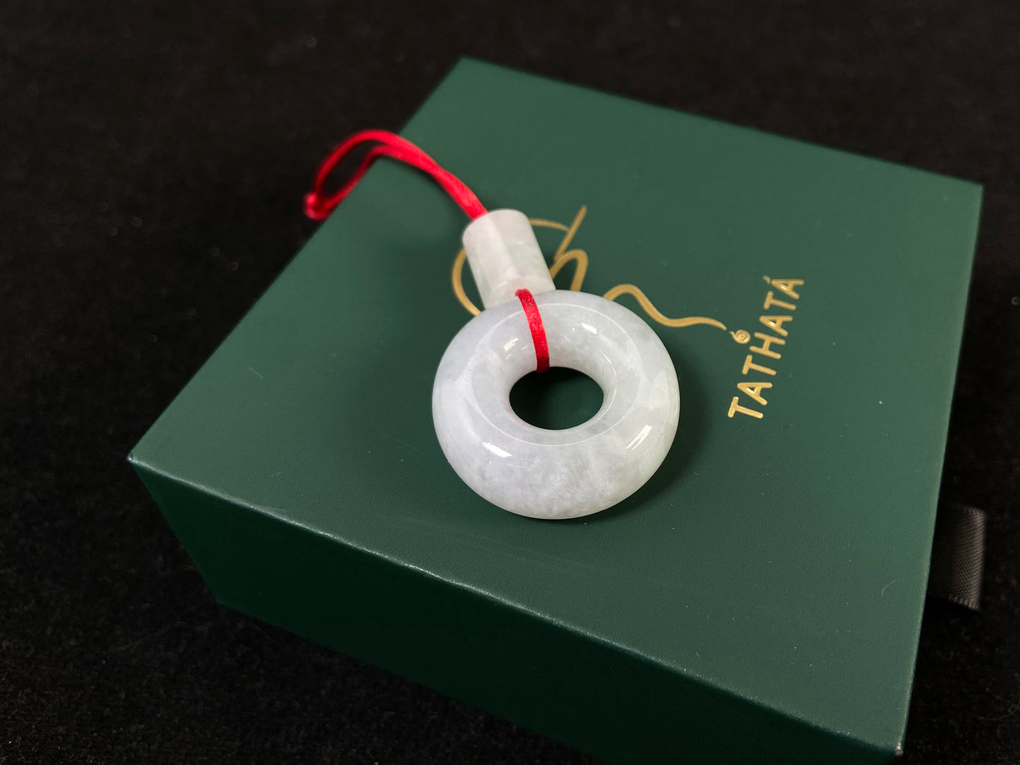 A milky white jadeite "Lu Lu Tong" pendant.