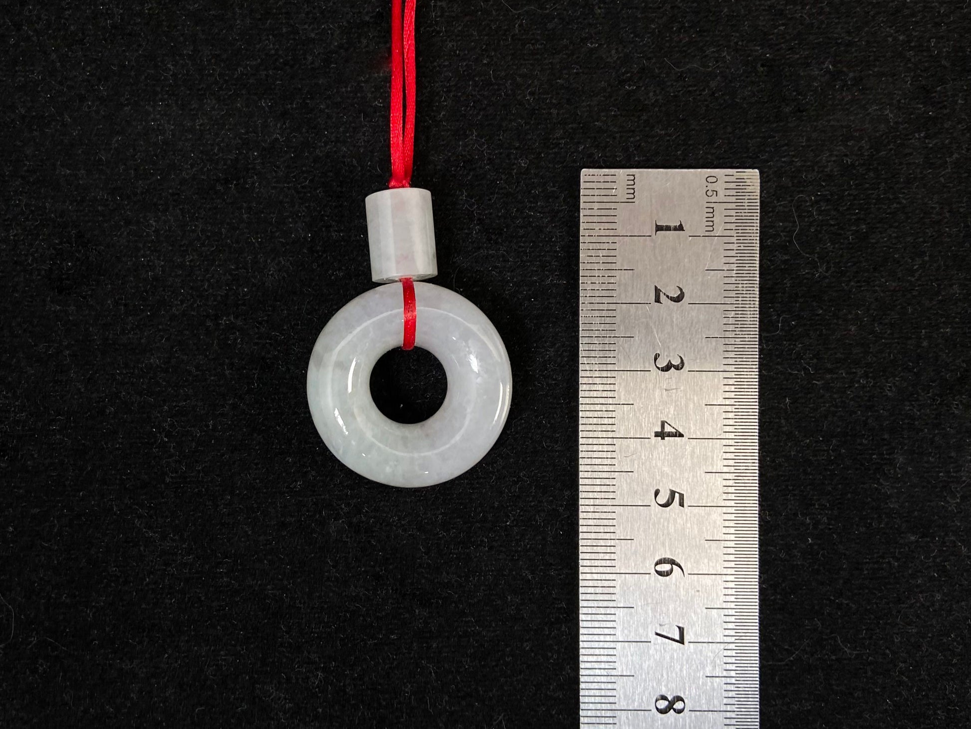 A milky white jadeite "Lu Lu Tong" pendant.