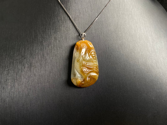 This jade pendant features a phoenix design in warm brown tones with subtle white accents, symbolizing nobility and good fortune.
