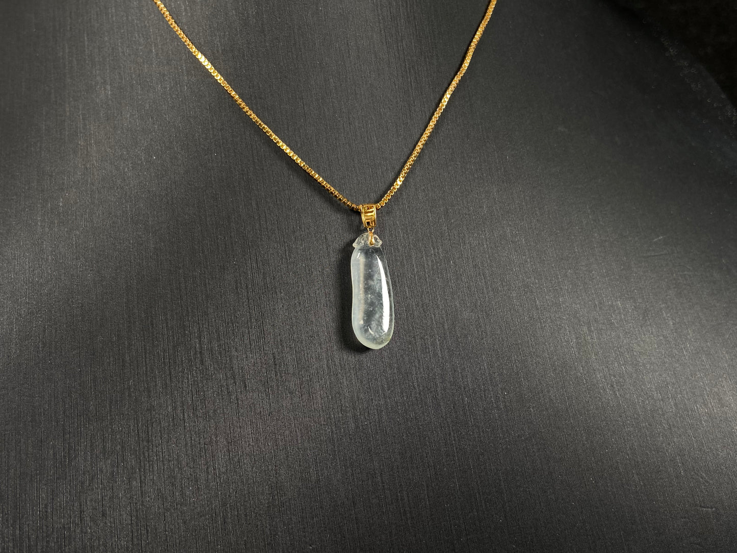 An ice jadeite pendant carved as a blessing melon.