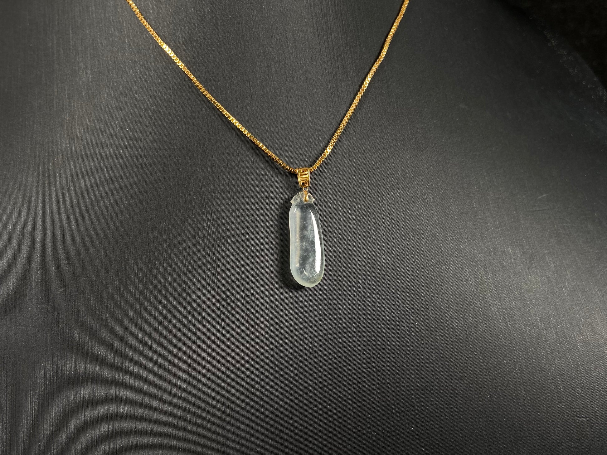 An ice jadeite pendant carved as a blessing melon.