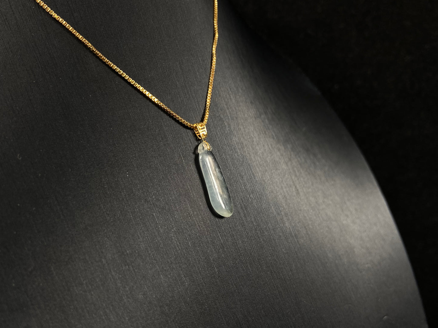 An ice jadeite pendant carved as a blessing melon.