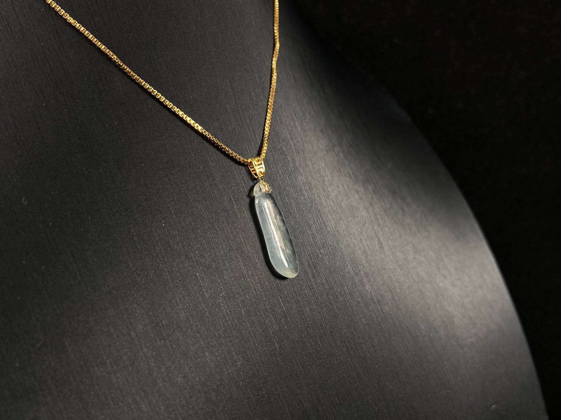 An ice jadeite pendant carved as a blessing melon.