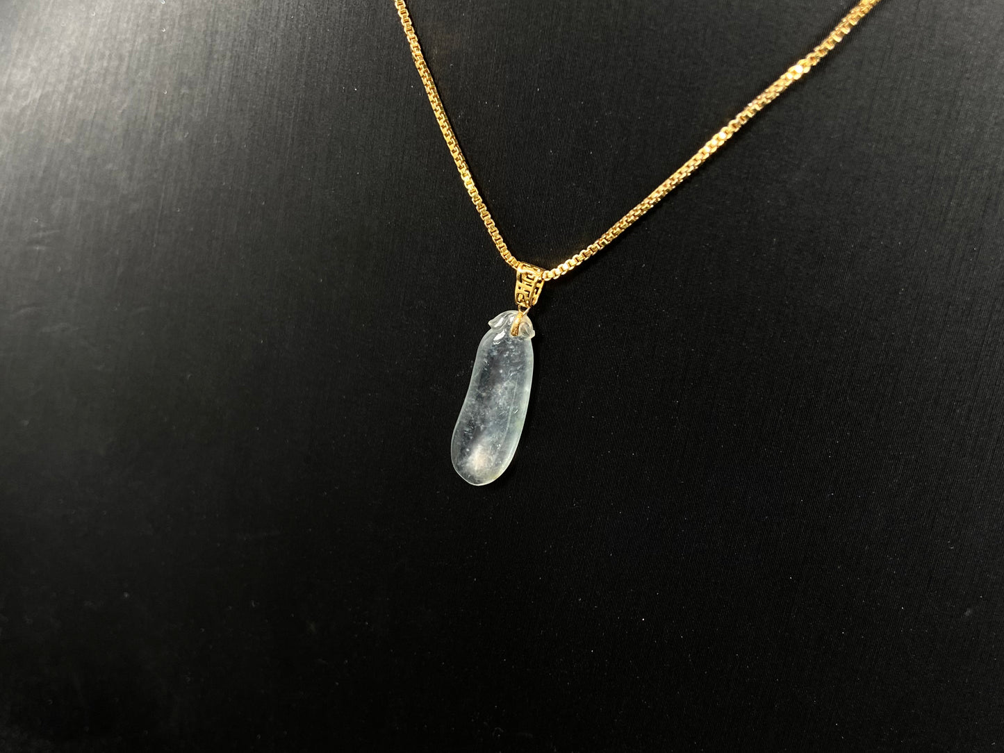 An ice jadeite pendant carved as a blessing melon.