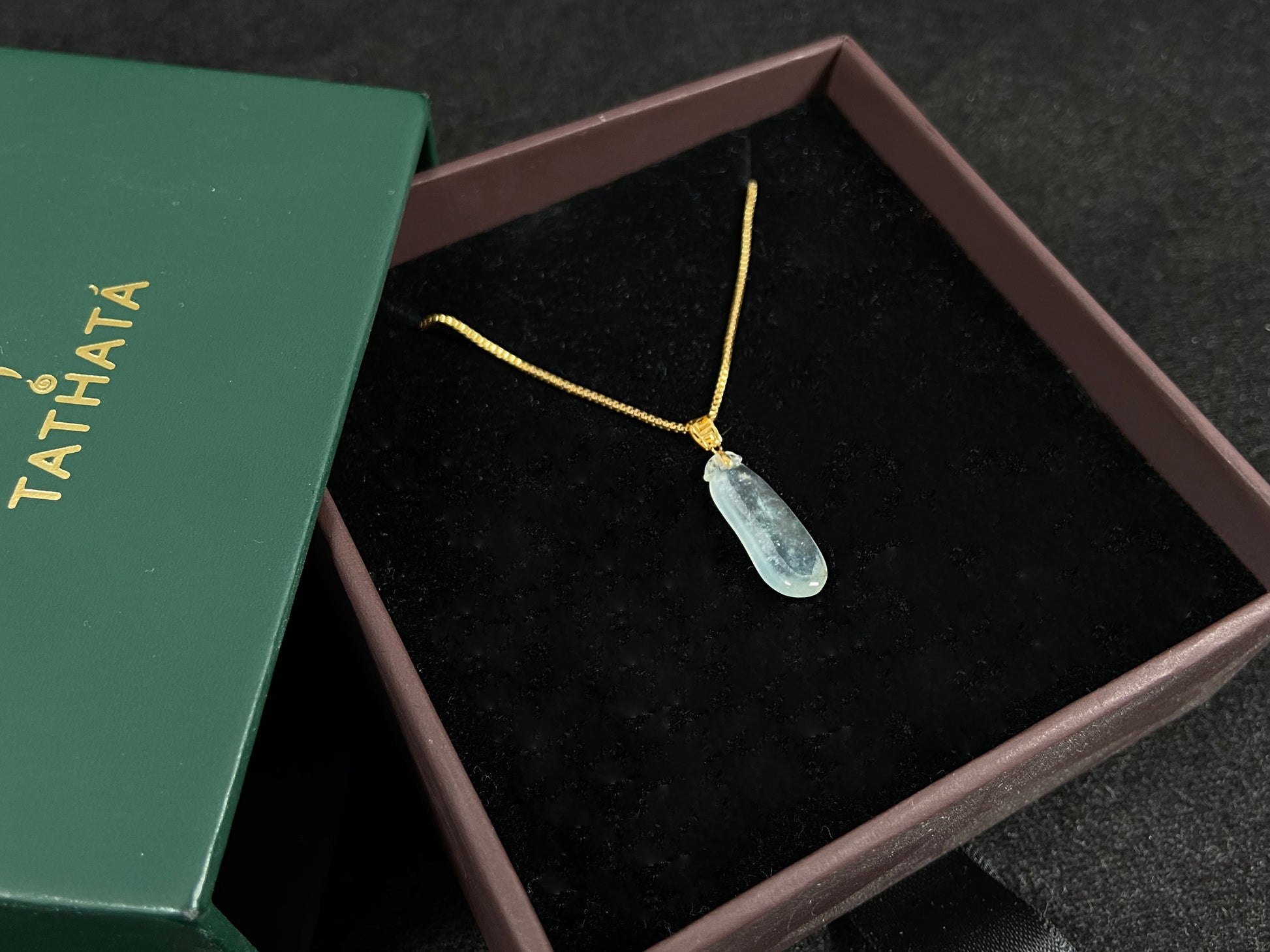 An ice jadeite pendant carved as a blessing melon.