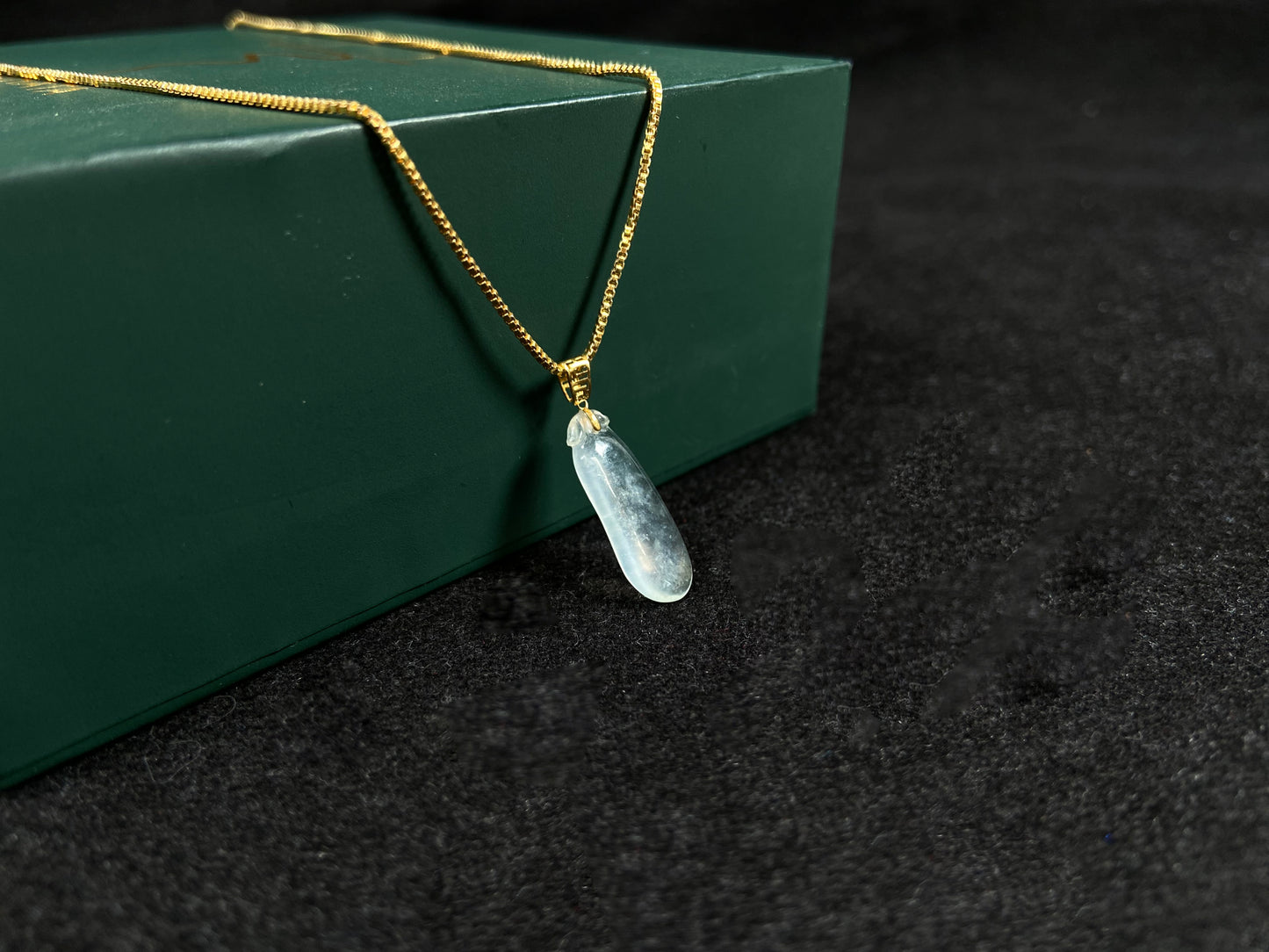 An ice jadeite pendant carved as a blessing melon.