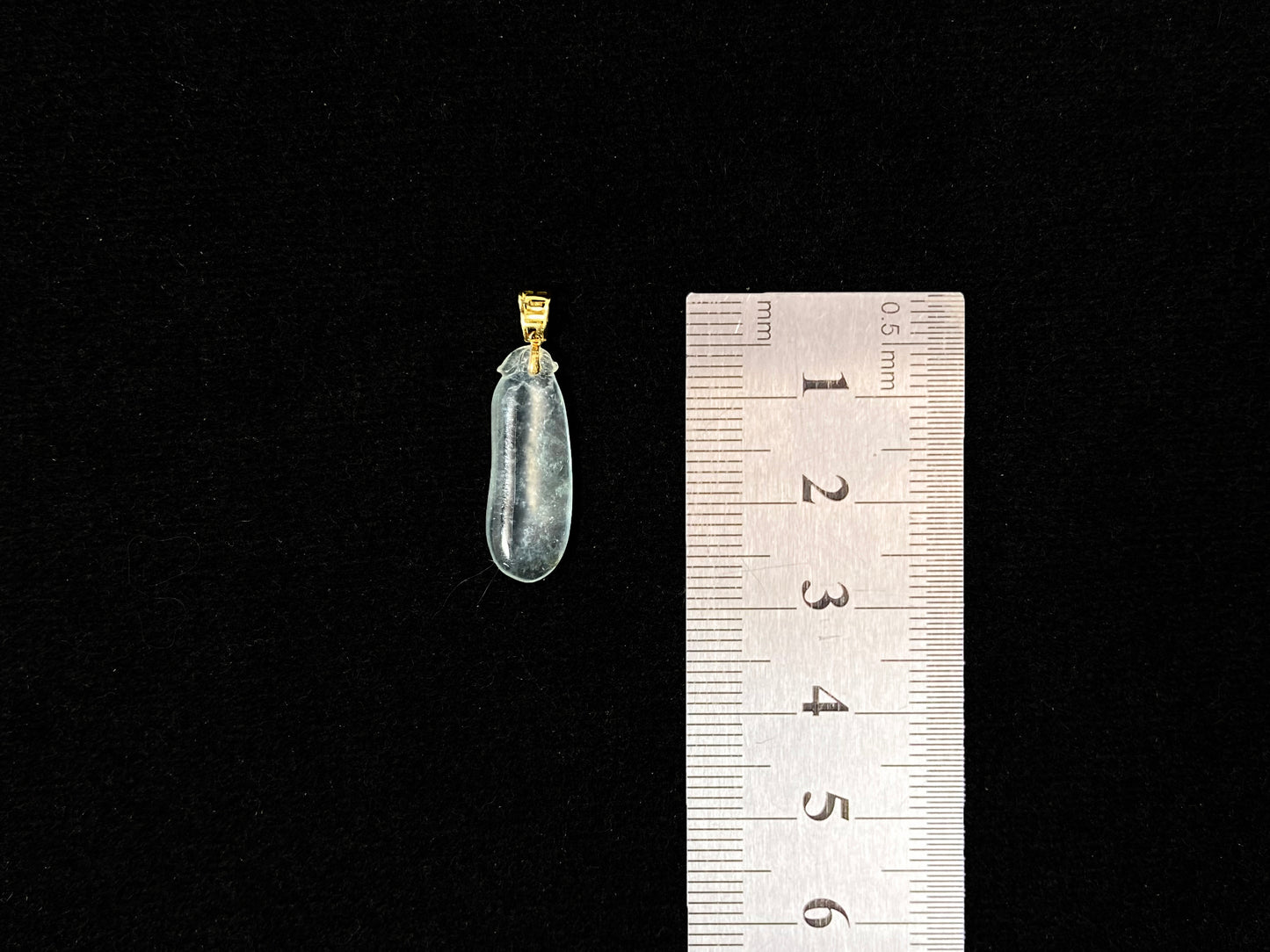 An ice jadeite pendant carved as a blessing melon.