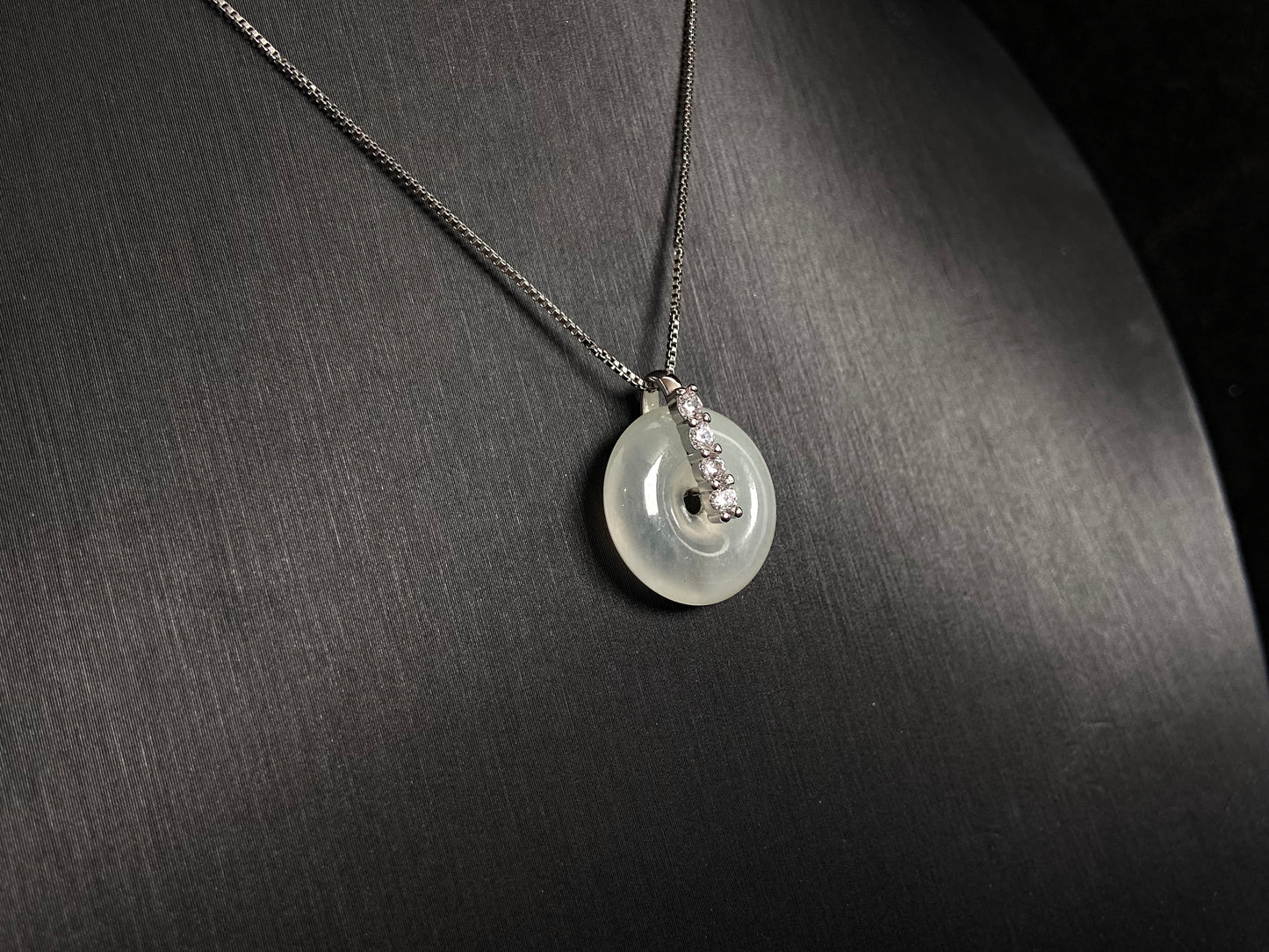 A serene icy clear jade circle pendant, embodying lifelong harmony and peace in its graceful form.