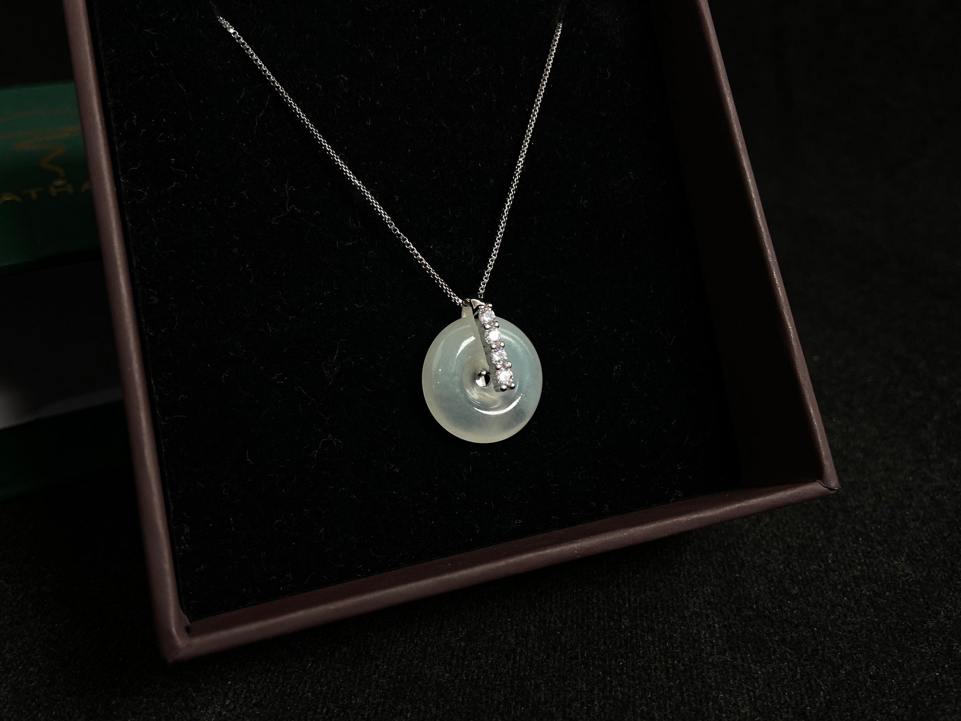 A serene icy clear jade circle pendant, embodying lifelong harmony and peace in its graceful form.