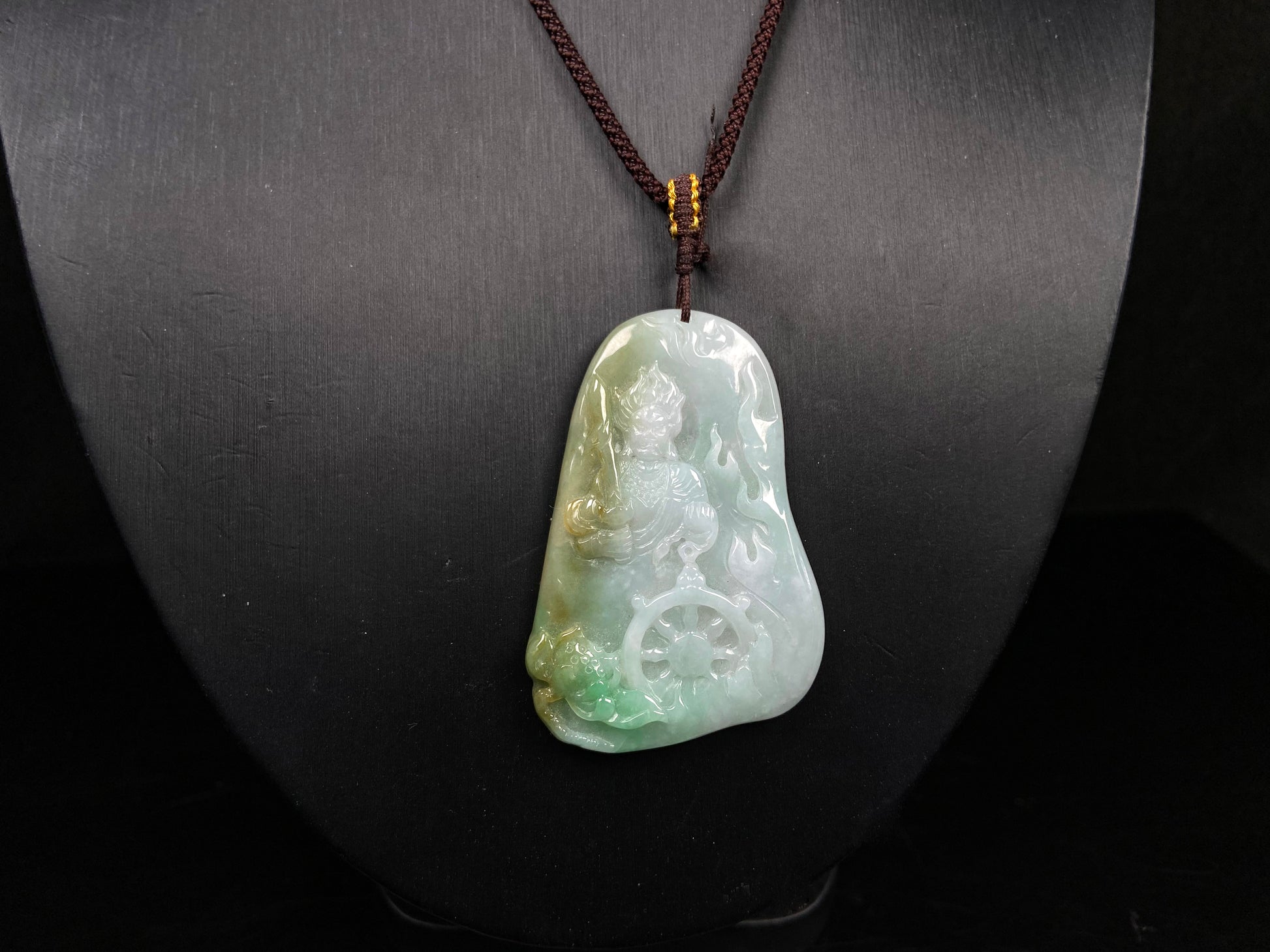 A green-yellow bodhisattva with dharma wheel jadeite pendant.
