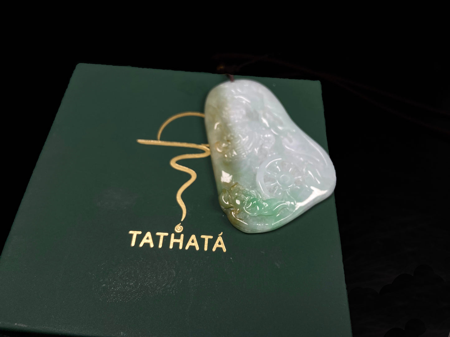 A green-yellow bodhisattva with dharma wheel jadeite pendant.