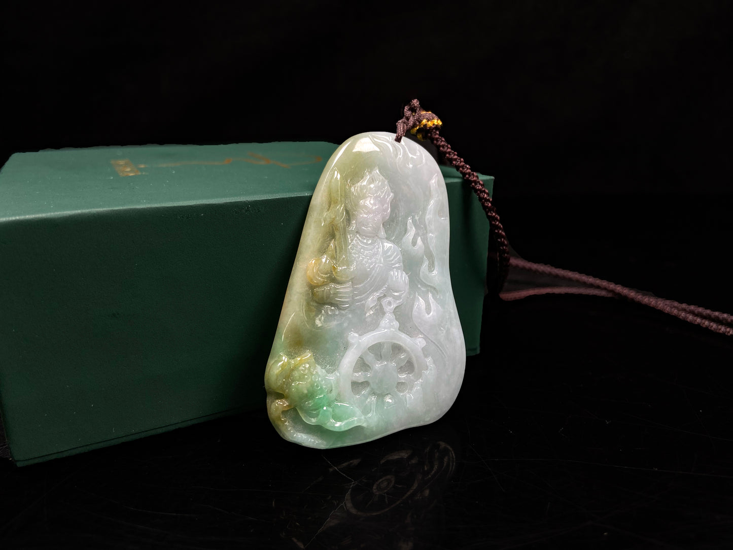 A green-yellow bodhisattva with dharma wheel jadeite pendant.