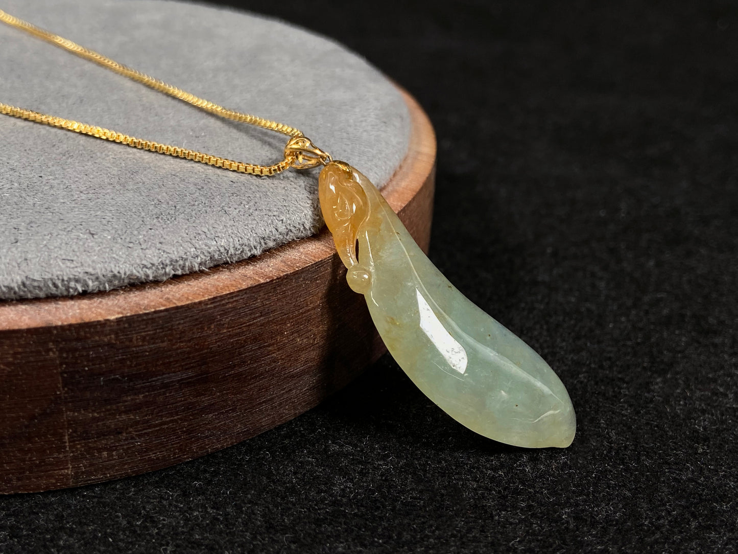 An icy jadeite "Fu Gua" pendant with gold speckles.