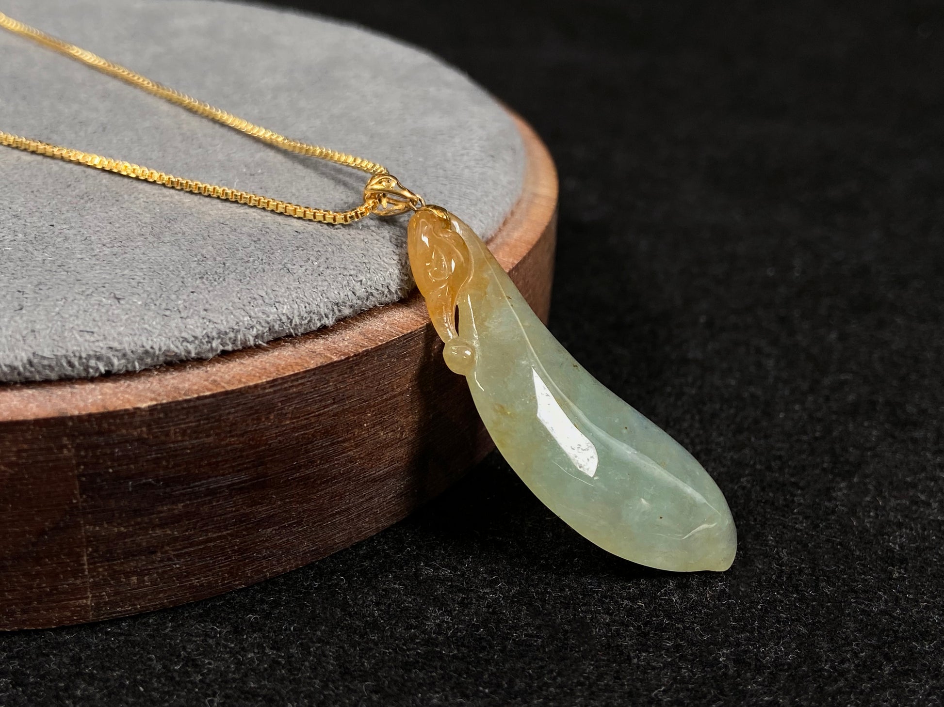 An icy jadeite "Fu Gua" pendant with gold speckles.