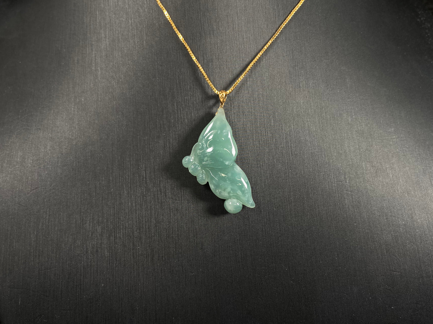 A light green jadeite butterfly pendant.