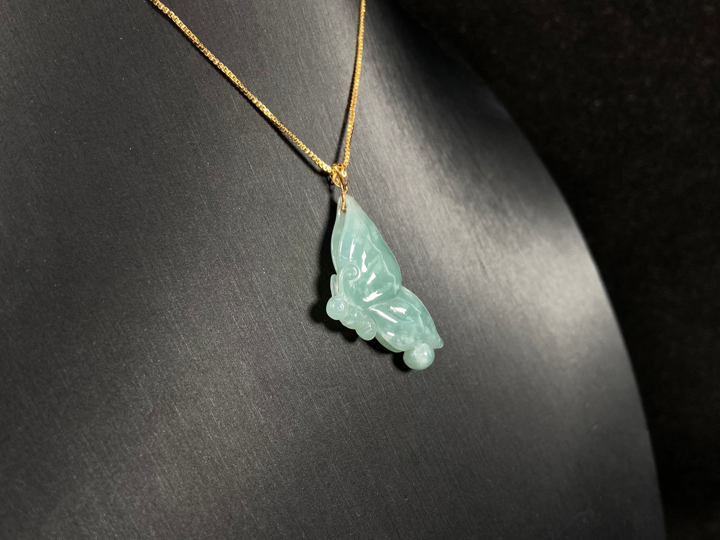 A light green jadeite butterfly pendant.