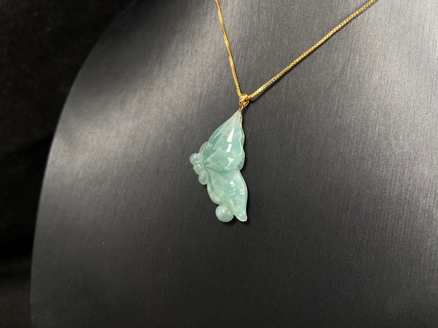 A light green jadeite butterfly pendant.