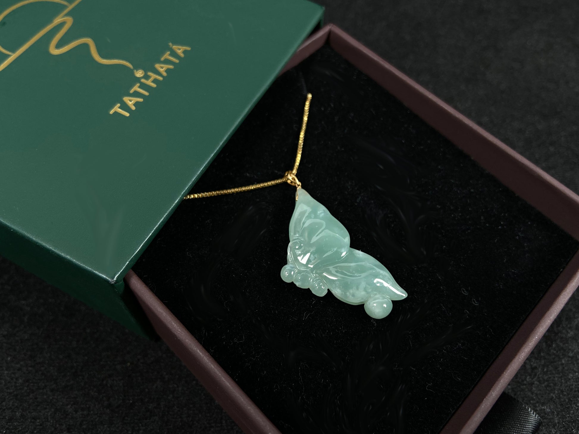 A light green jadeite butterfly pendant.