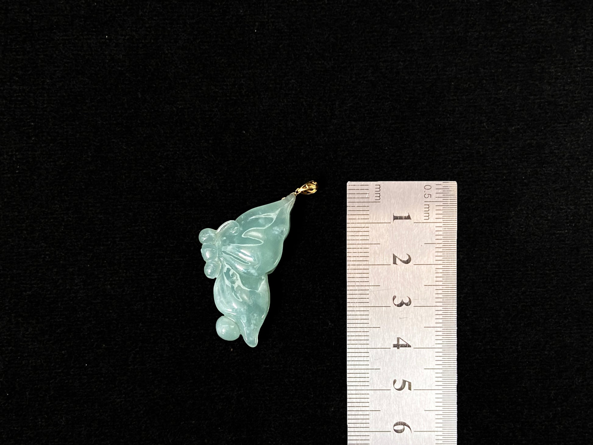 A light green jadeite butterfly pendant.