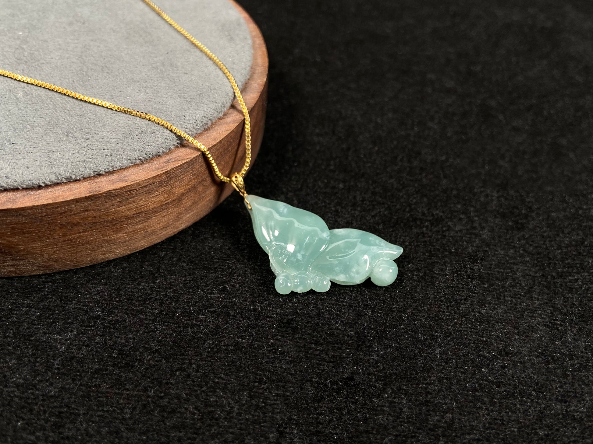 A light green jadeite butterfly pendant.