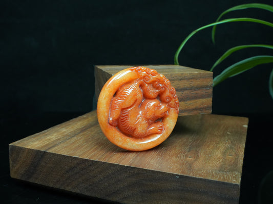A glowing orange red dog loose jadeite.