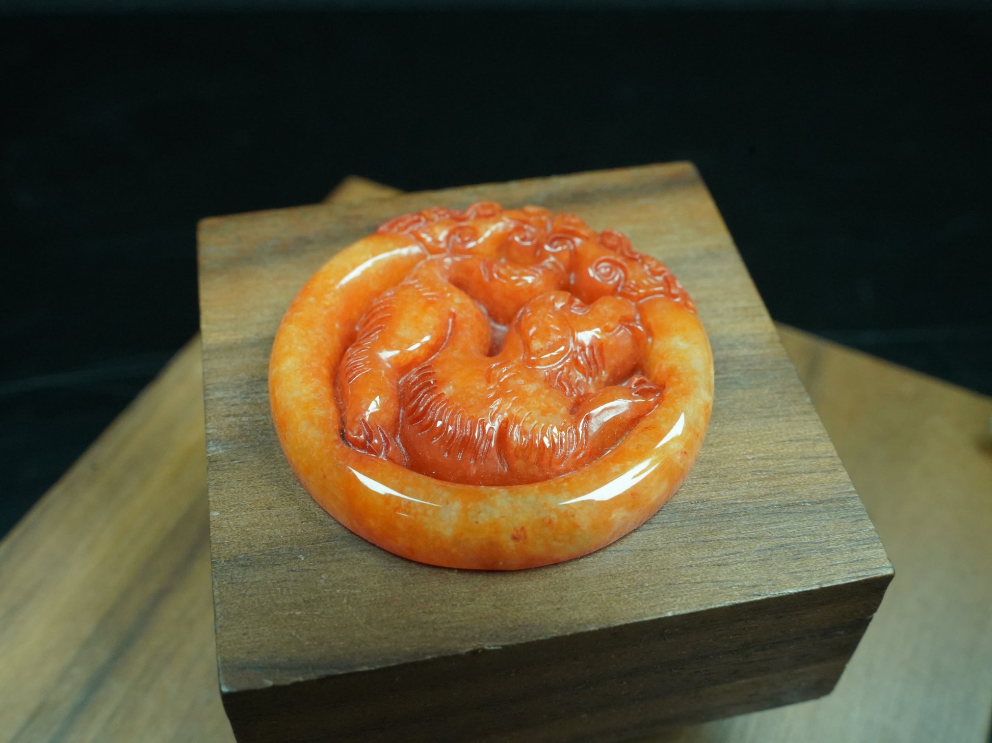 A glowing orange red dog loose jadeite.