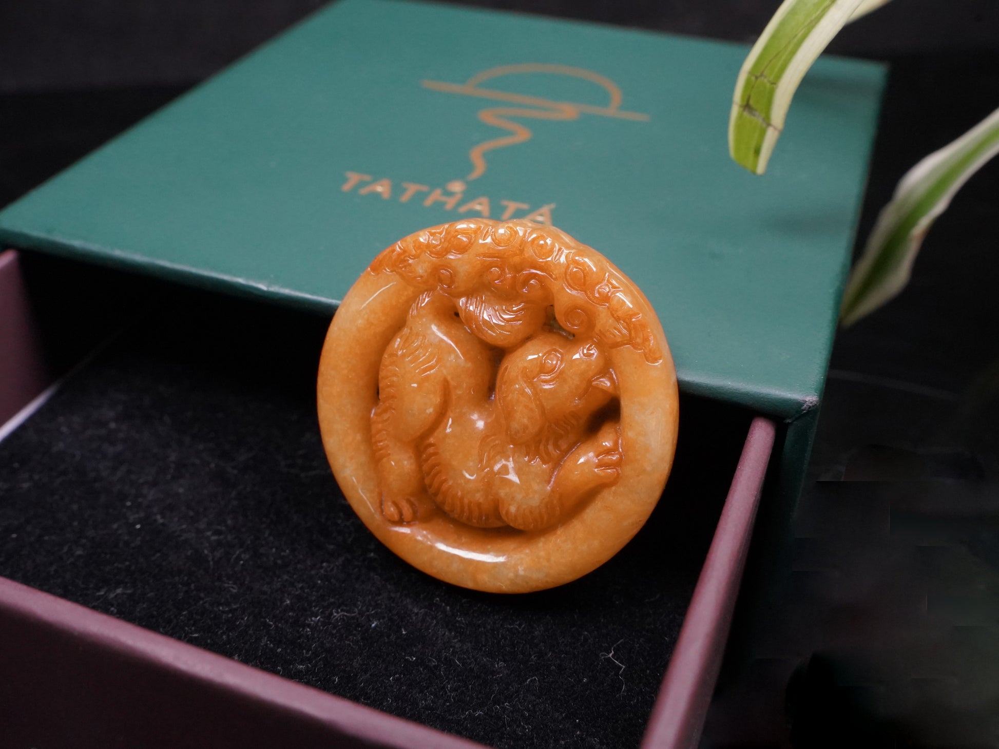 A glowing orange red dog loose jadeite.