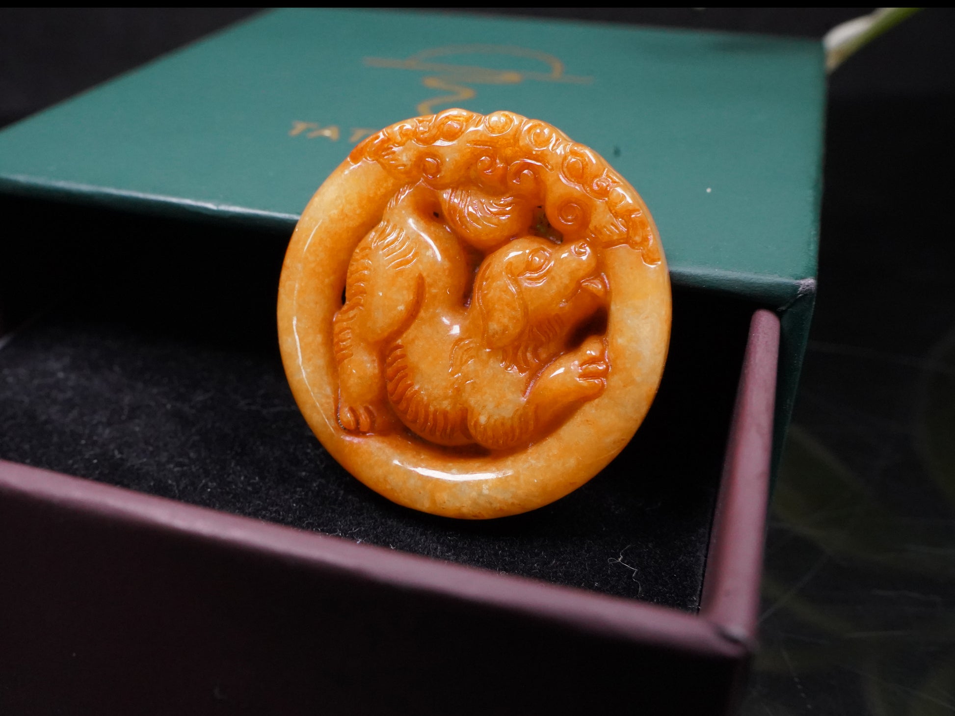 A glowing orange red dog loose jadeite.